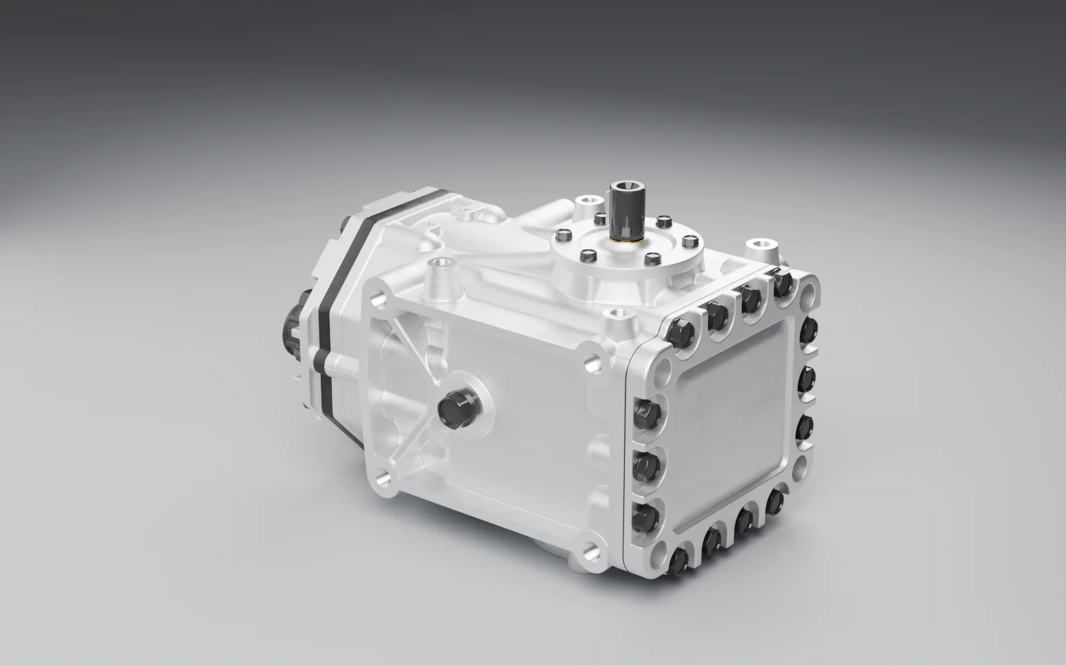 A bare air-conditioning compressor on a grey studio floor: a bolted aluminium housing with a keyed drive shaft on top and rubber caps on its ports