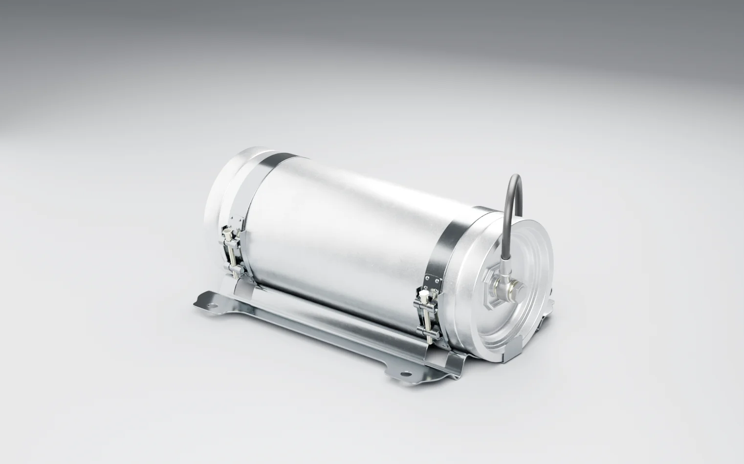 A fixed fire suppression cylinder on a grey studio floor, strapped into a cradle, with a hose from one end to a ribbed unit mounted alongside it
