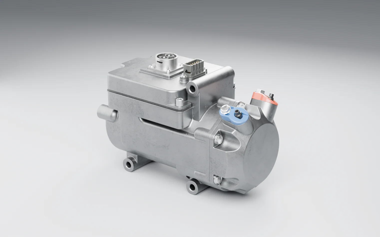 An electric air-conditioning compressor on a grey studio floor: the compressor body with a box on top carrying a round and a rectangular connector, and blue and red caps on its ports